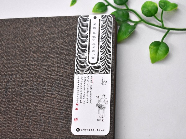 把金属书签放进书里，为新的世界句读